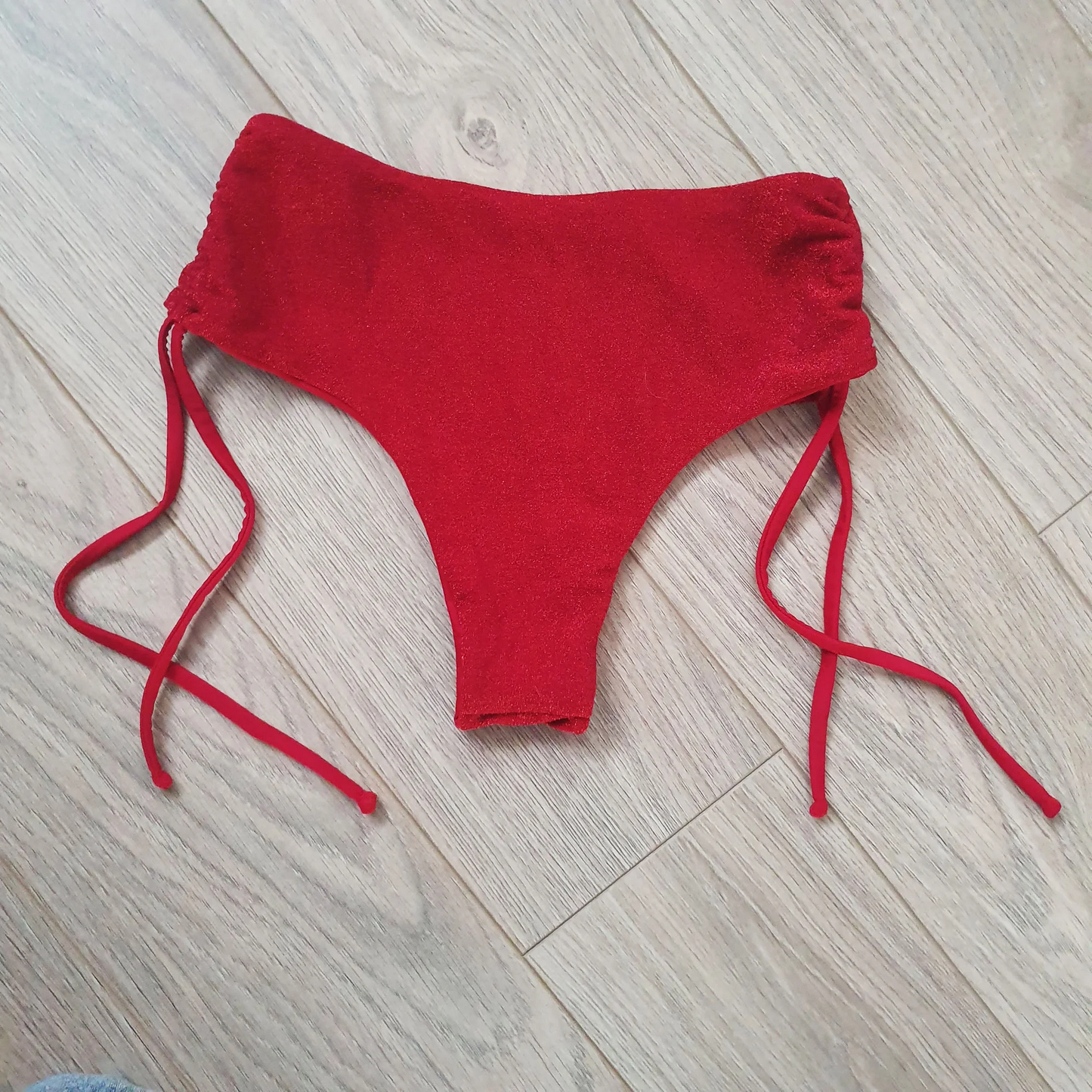 Glitter Red Cheeky Shorts - Back view displaying the elegant red glitter detail and adjustable sides for a perfect fitting pole dance shorts. Pole dance, pole, pole dance outfit, pole wear, pole shorts, pole junkie, pole clothing.