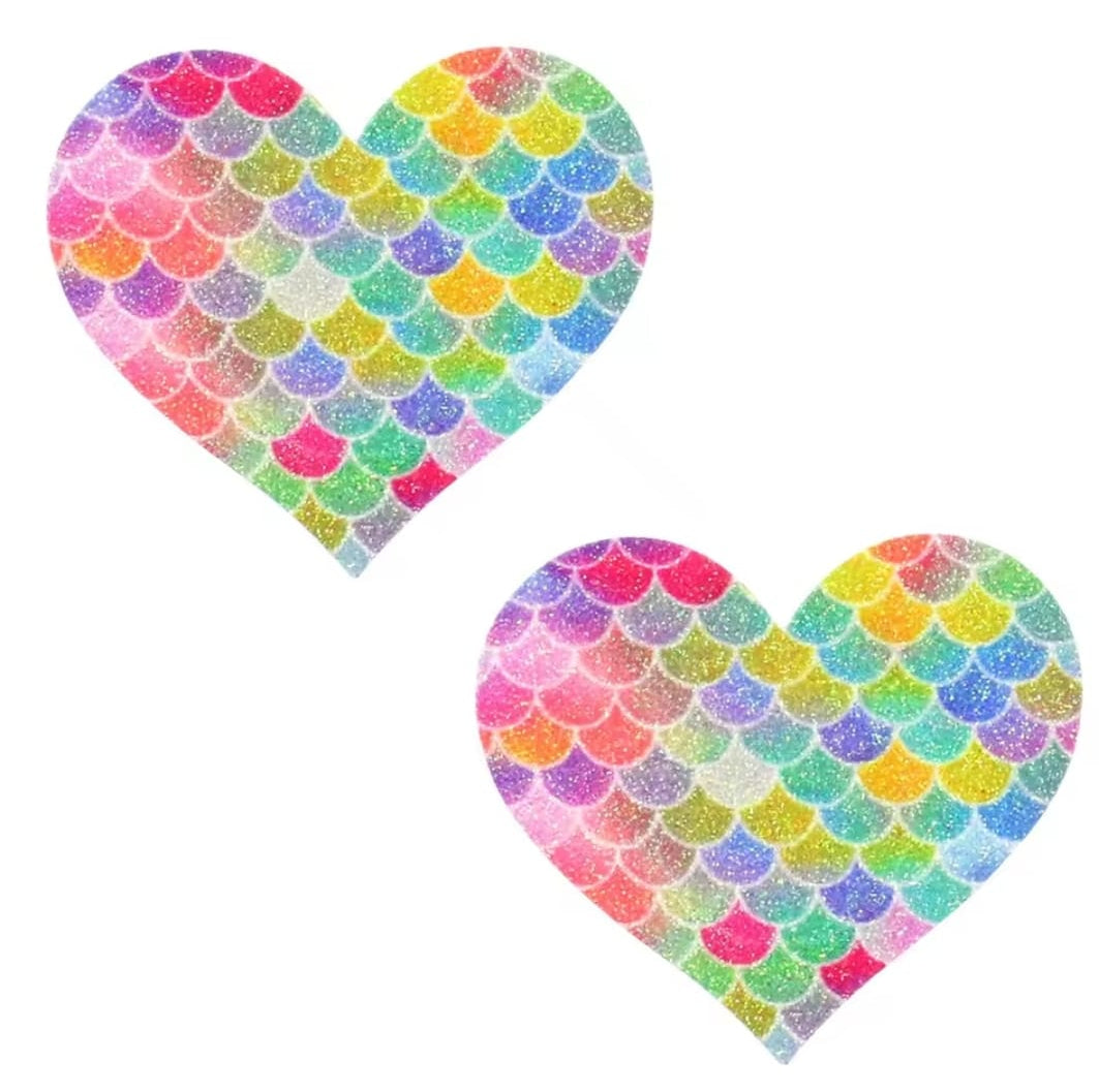 Pair of rainbow glitter star nipple pasties with mermaid scale pattern, designed for pole dance, raves, and performance wear. Nipple pasties for pole dancers, nipple covers for dancers.