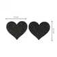 Midnight black glitter heart-shaped nipple covers, reusable and breathable for pole fitness and exotic dance routines.